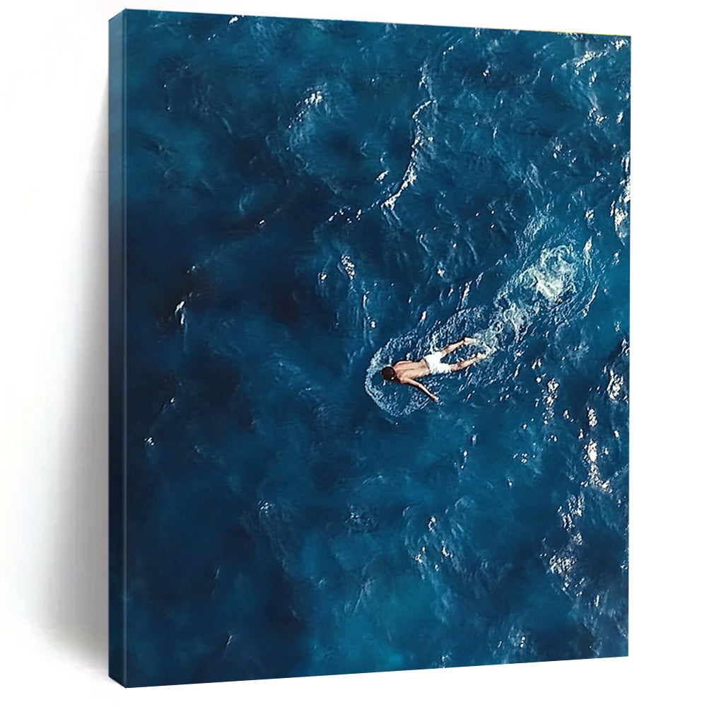 Large abstract painting depicting a solitary man in deep blue ocean waves wearing white swim trunks evoking solitude and calmness amidst chaos.STSC1057