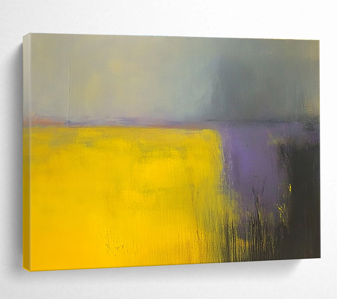 A large abstract painting featuring vibrant yellow and gray fields with subtle purple hues, enhanced by dynamic brushstrokes and a blurred background.SC475