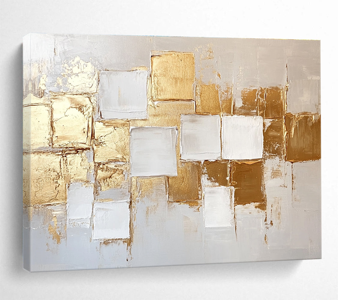 Large abstract painting in white and gold featuring textured square block patterns and soft lighting for an elegant touch.SC292