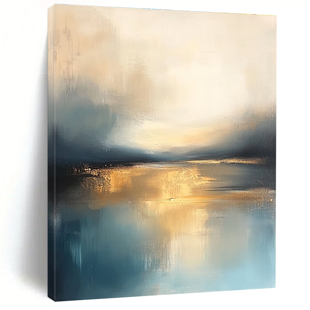 Large abstract painting featuring soft blue and gold tones with a calm sea reflections dramatic clouds and a tranquil sky.STSC103