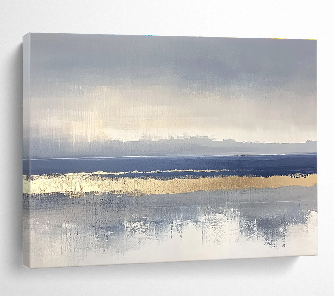Large abstract painting featuring soft blue and gray tones with gold accents and visible brush strokes on a neutral background.SC038