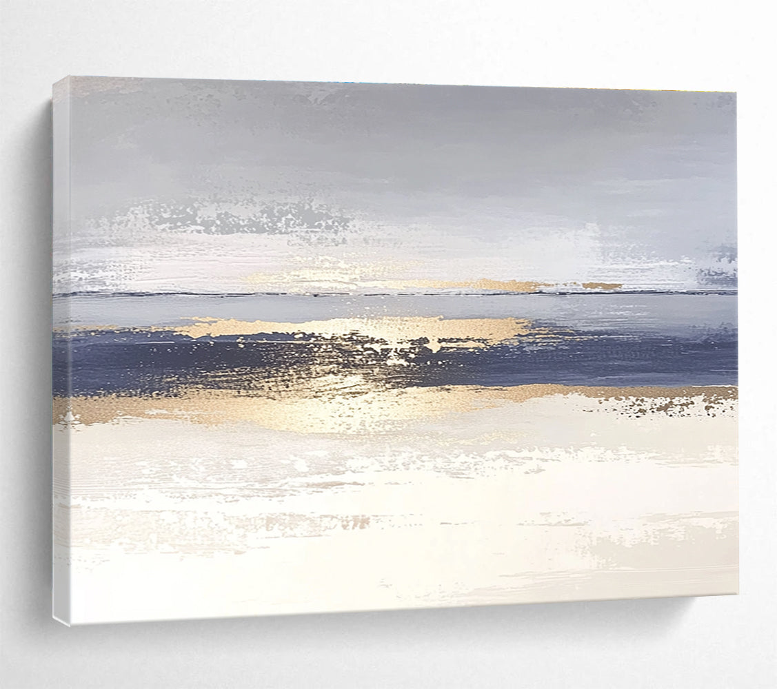 Large abstract painting with soft light blue and gray tones featuring metallic gold lines depicting water ripples on serene sand.SC007