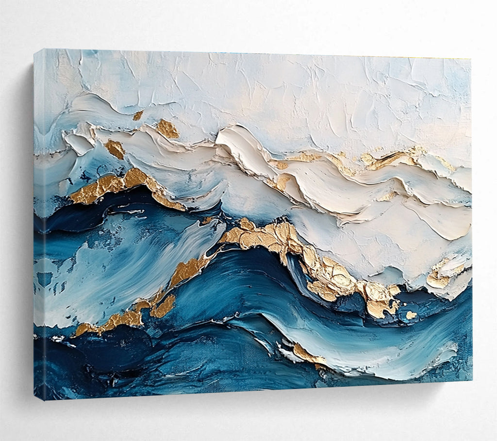 Large abstract painting featuring ocean waves in textured white and blue hues with gold accents for depth and elegance.SC102