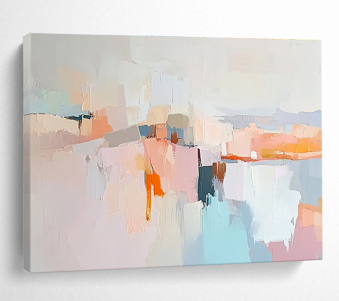 Large abstract painting in soft pastels featuring hills mountains a light grey sky peach-pink clouds and serene water for a calming effect.SC353