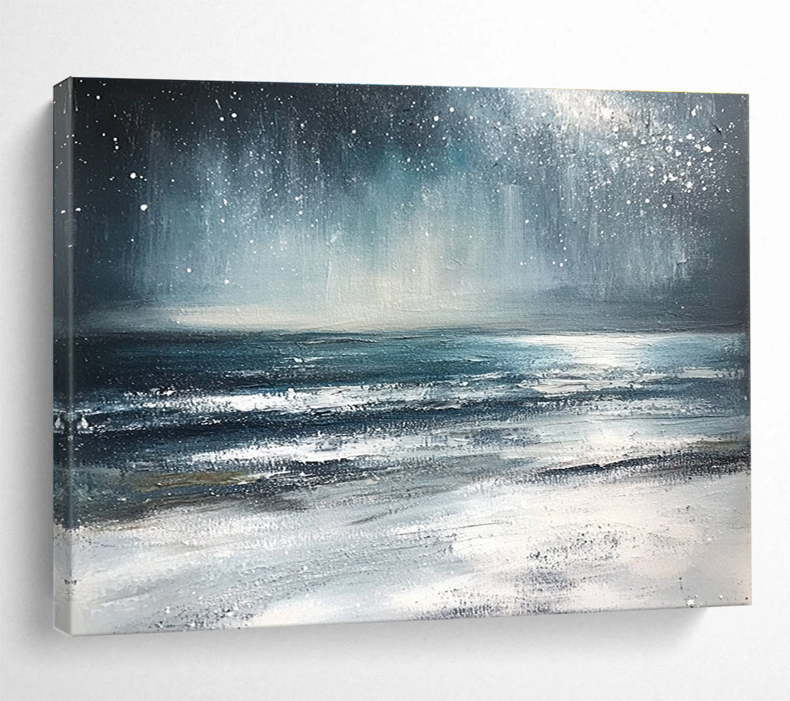 Large abstract painting depicting a winter ocean scene with dark blue and gray tones a starry white sky and sandy beach resembling snow.SC412