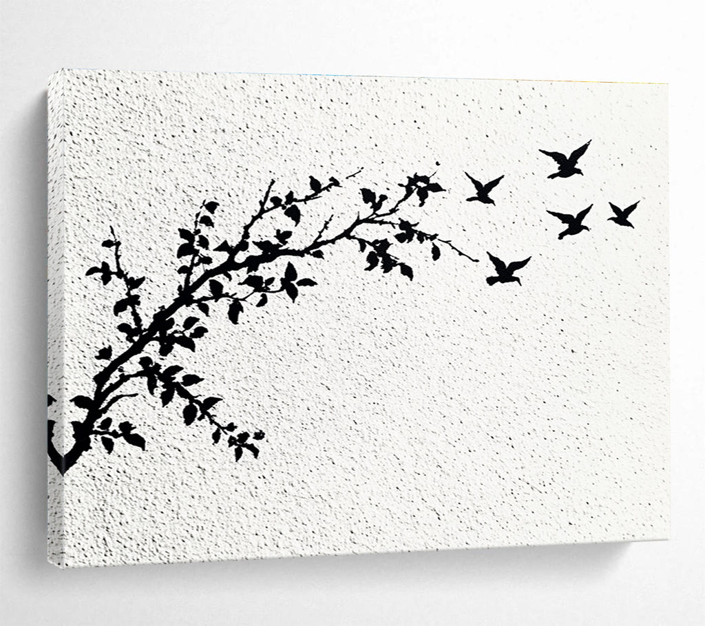 A large abstract painting featuring delicate branches with leaves and black and white flying birds against an off-white wall.SC434