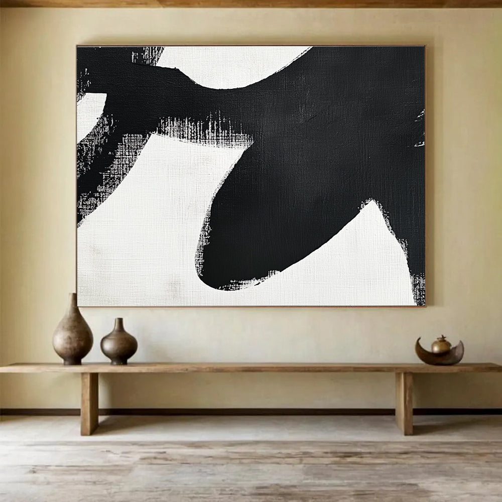 Large abstract painting in black and white featuring simple shapes and broad brush strokes inspired by an orca's tail flippers.SC016