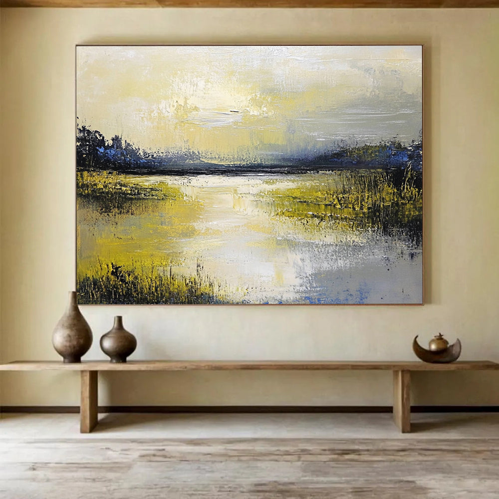Large abstract painting featuring a serene lake and sky in soft yellow green blue and gray tones with thick textured paint.SC078