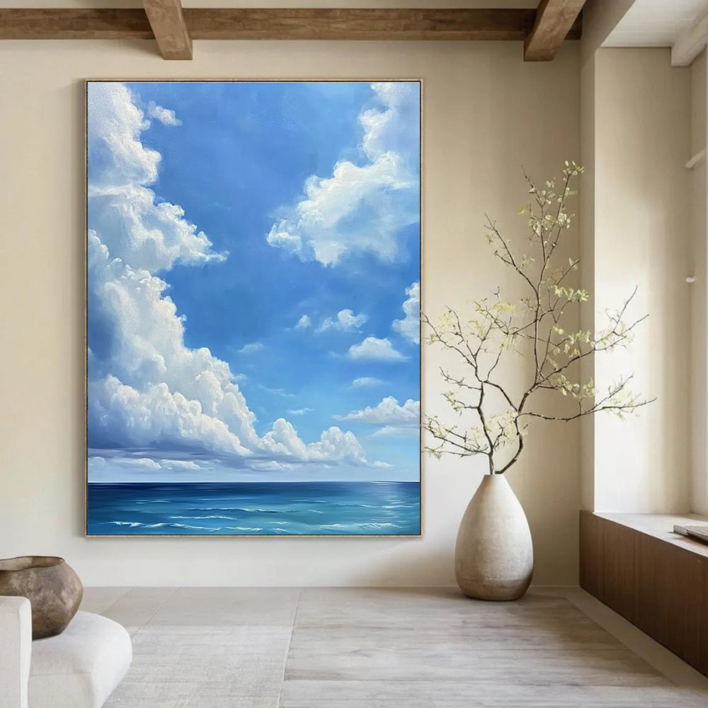 A large abstract painting featuring a blue sky with white clouds and a vast ocean below in a minimalist oil painting style.STSC923