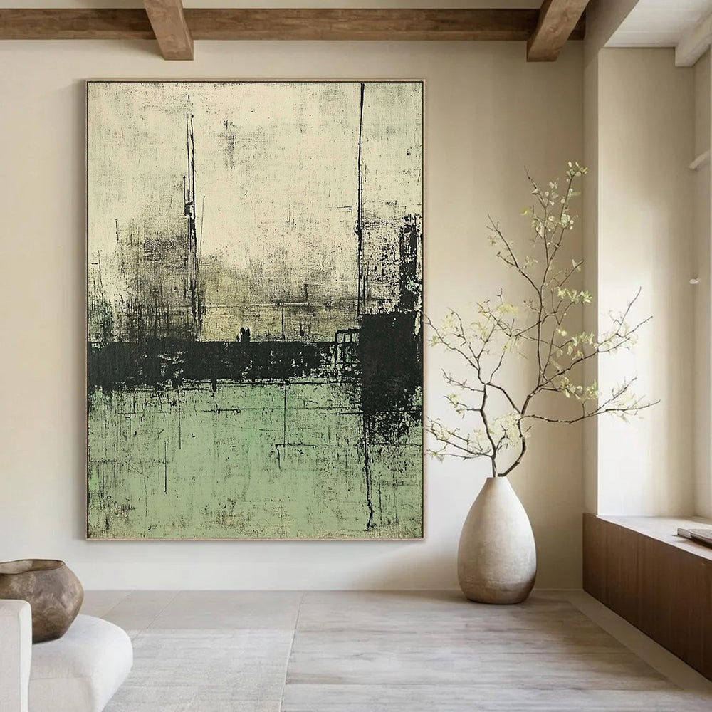 Large abstract painting featuring muted green and gray tones depicting a desolate landscape with distant buildings and water.STSC421