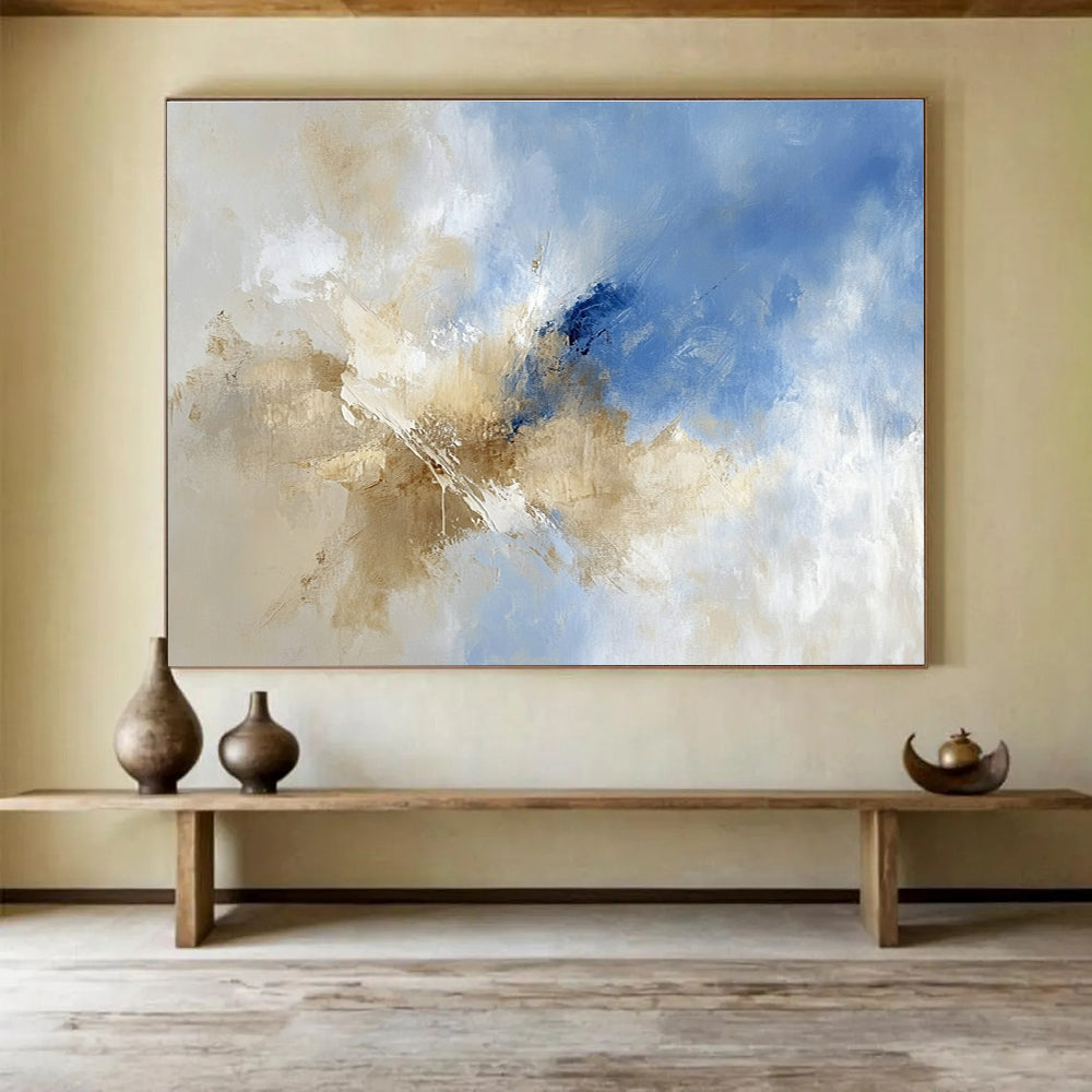 Large abstract painting featuring blue and beige hues with clouds in the sky, blending earthy tones of brown for a serene atmosphere.SC020