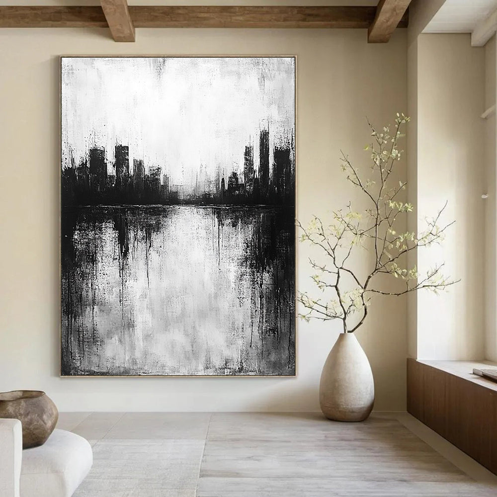 Large abstract painting in black and white with city silhouette and lake reflection evokes calmness and mystery through minimalist heavy brushstrokes.STSC215