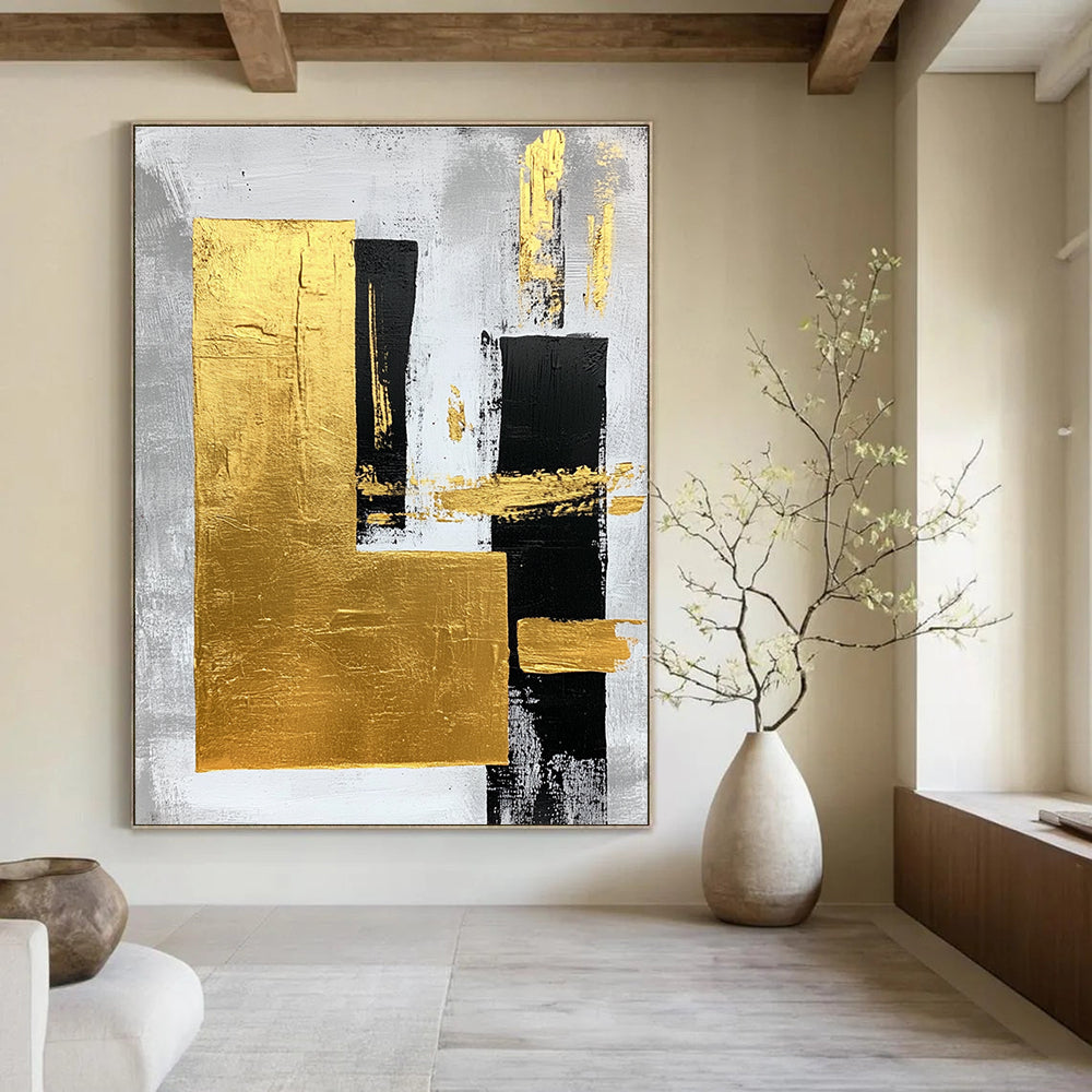 Large abstract art painting featuring gold foil bold strokes and minimalist black lines on a gray background creating an elegant atmosphere.STSC015