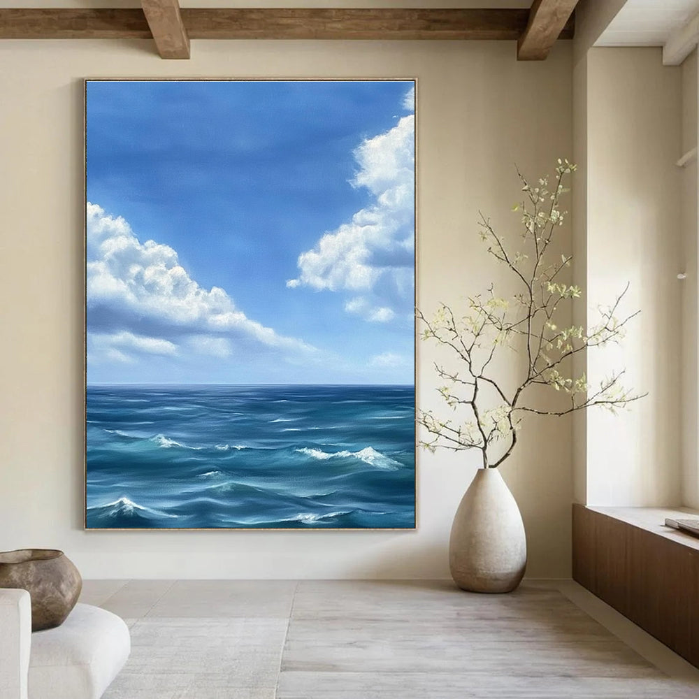 Large abstract painting depicting a tranquil ocean scene with gentle waves under a vast blue sky and soft white clouds in Monet's style.STSC1215