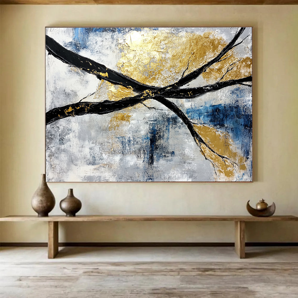Abstract painting featuring black and white branches with gold leaf accents against a serene blue sky background.SC367