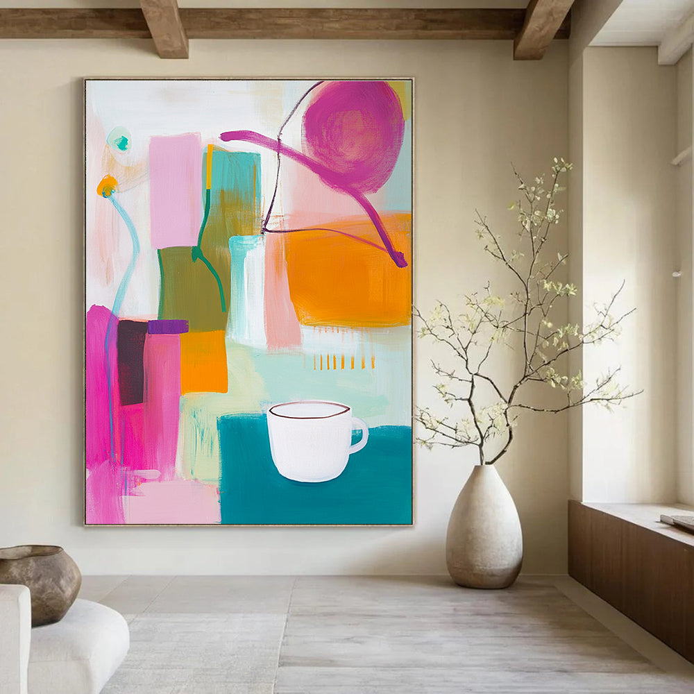 An abstract painting features vibrant pink green and yellow shapes with an orange object and a white cup on top alongside blue and purple lines.STSC787
