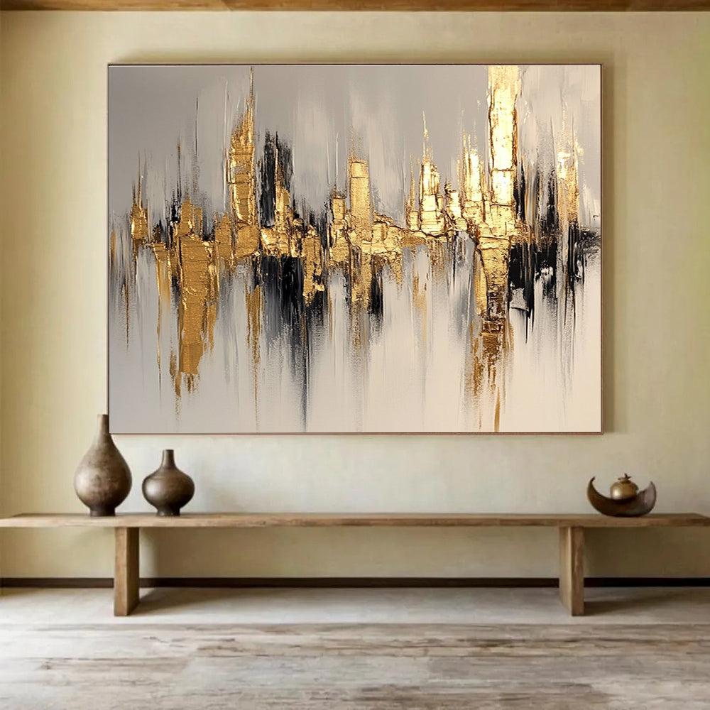 Large abstract painting of a cityscape in gold and white, featuring bold brush strokes on a white background with neutral tones.SC170