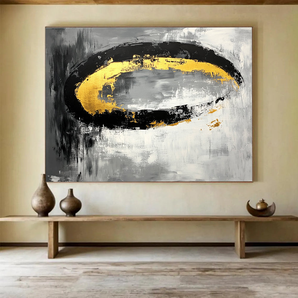 Large abstract painting featuring black white gray tones with gold accents and oval brush strokes on canvas.SC137
