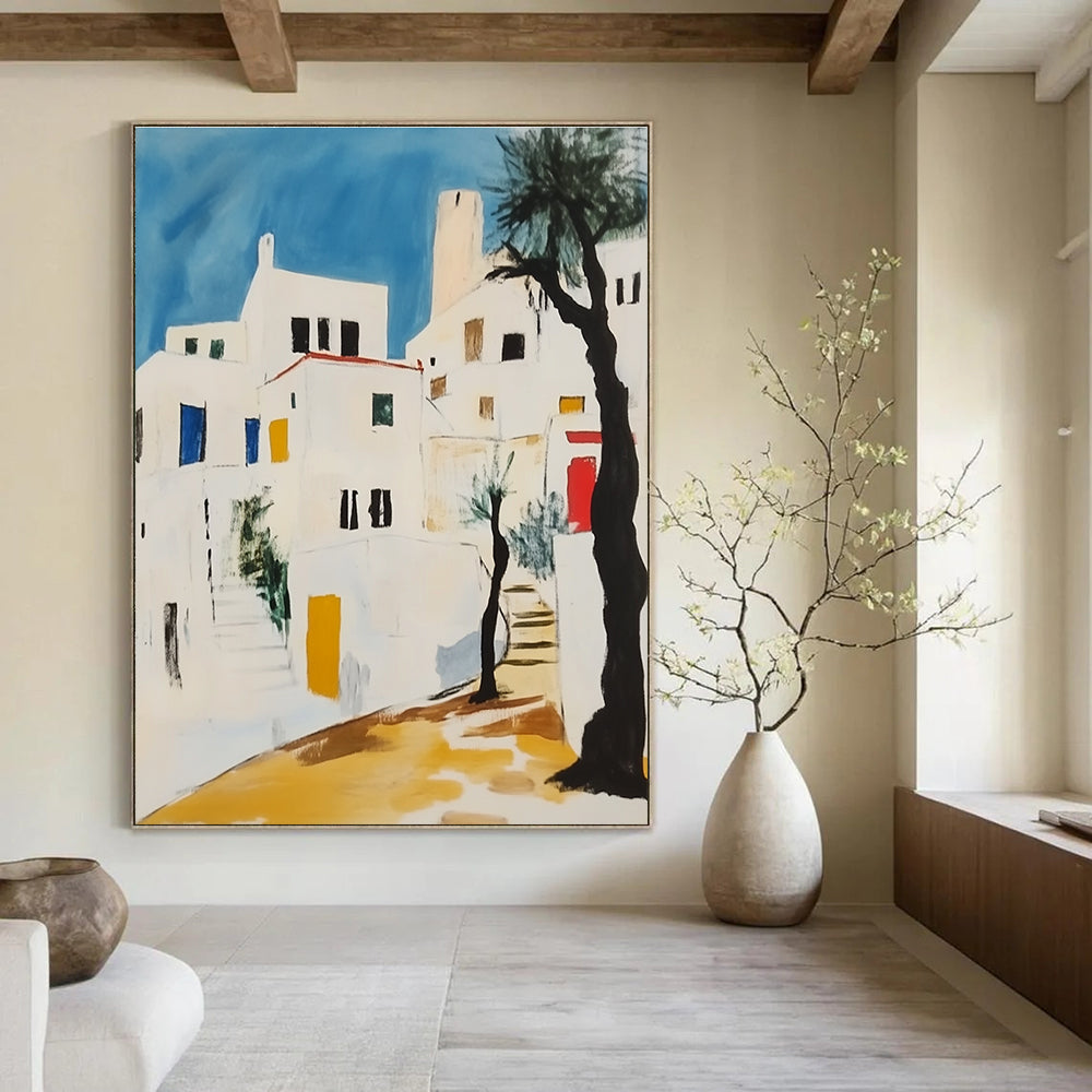 Abstract painting featuring white Greek buildings with black lines yellow accents and red elements against a light blue sky with greenery and a lone tree.STSC1106