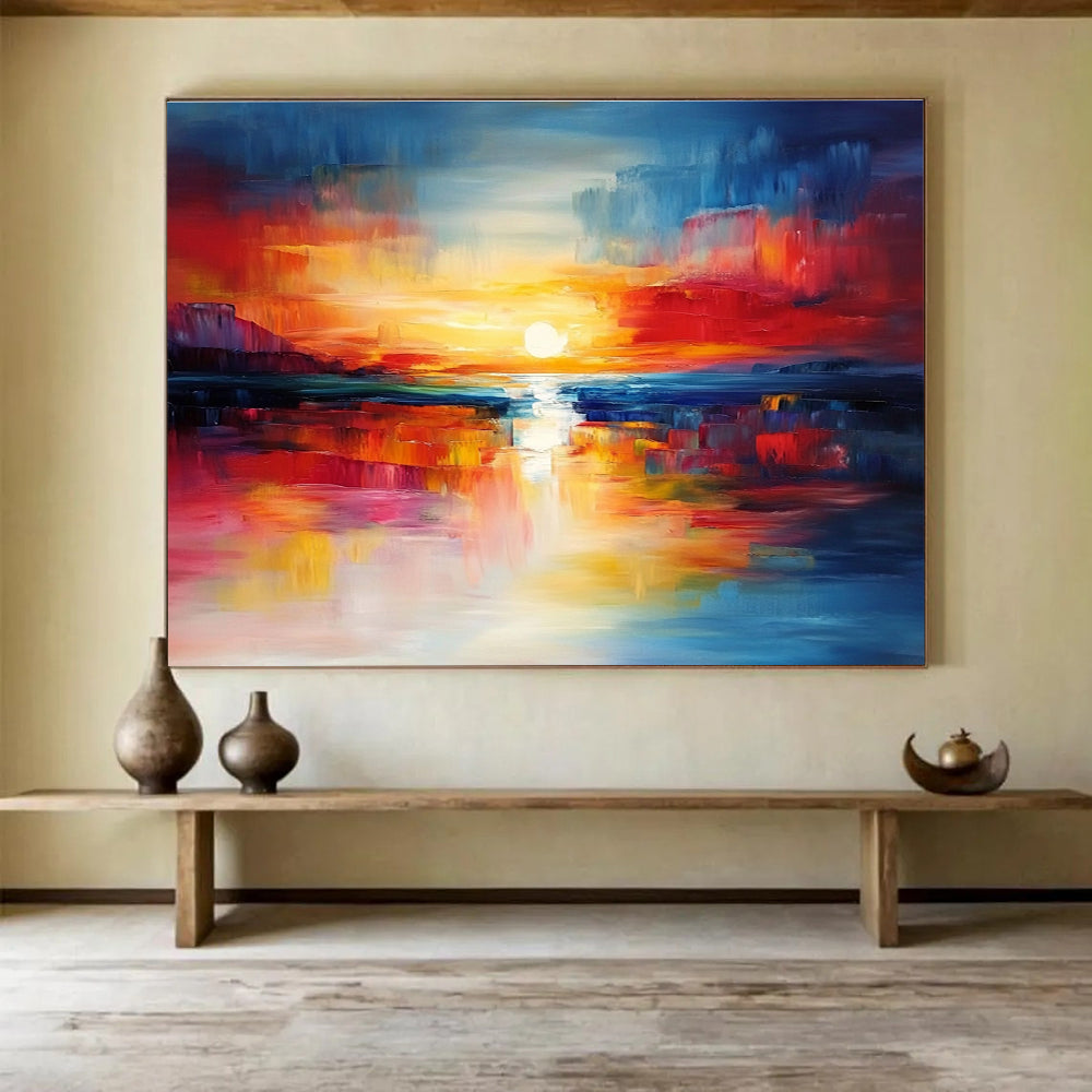 A large abstract painting capturing a vibrant sunset with blue and red hues reflecting on calm waters, creating a dynamic central composition.SC561