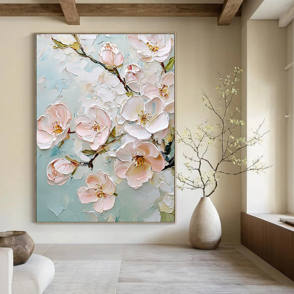 Large abstract painting featuring delicate cherry blossoms in soft pink and white against a light blue background with rich impasto texture.STSC875