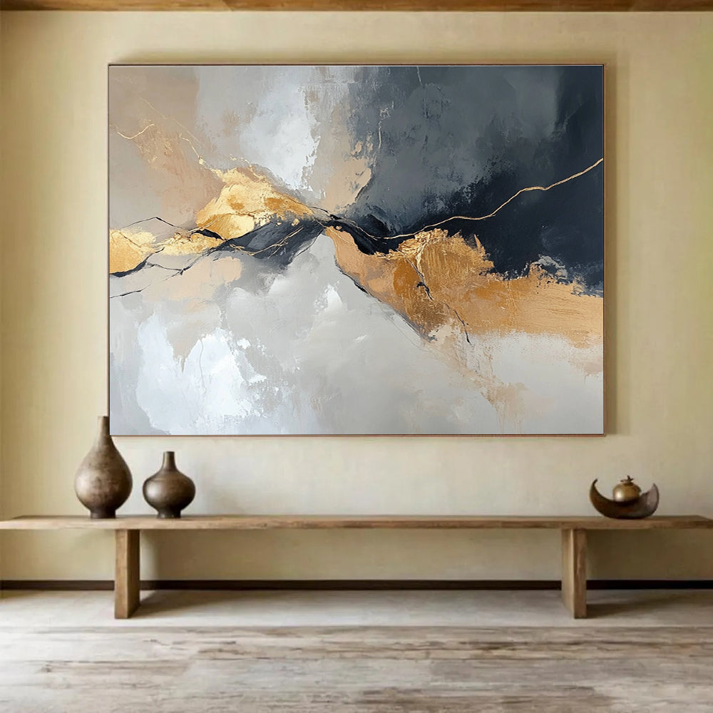 Large abstract painting with an aerial view in gray and beige colors featuring minimalistic shapes and brush strokes enhanced with gold accents.SC104