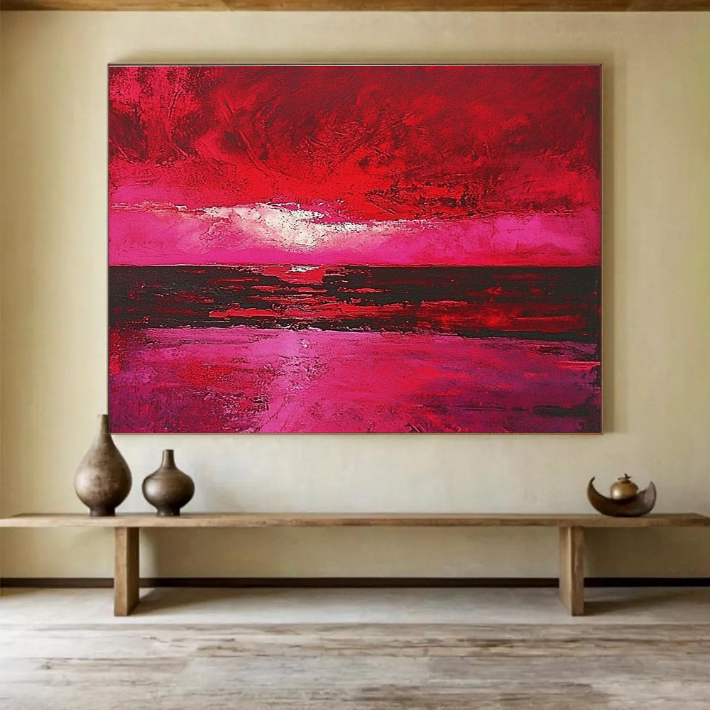 Large abstract painting depicting a red sky over the sea with hues of pink and crimson capturing the beauty of a sunset.SC273