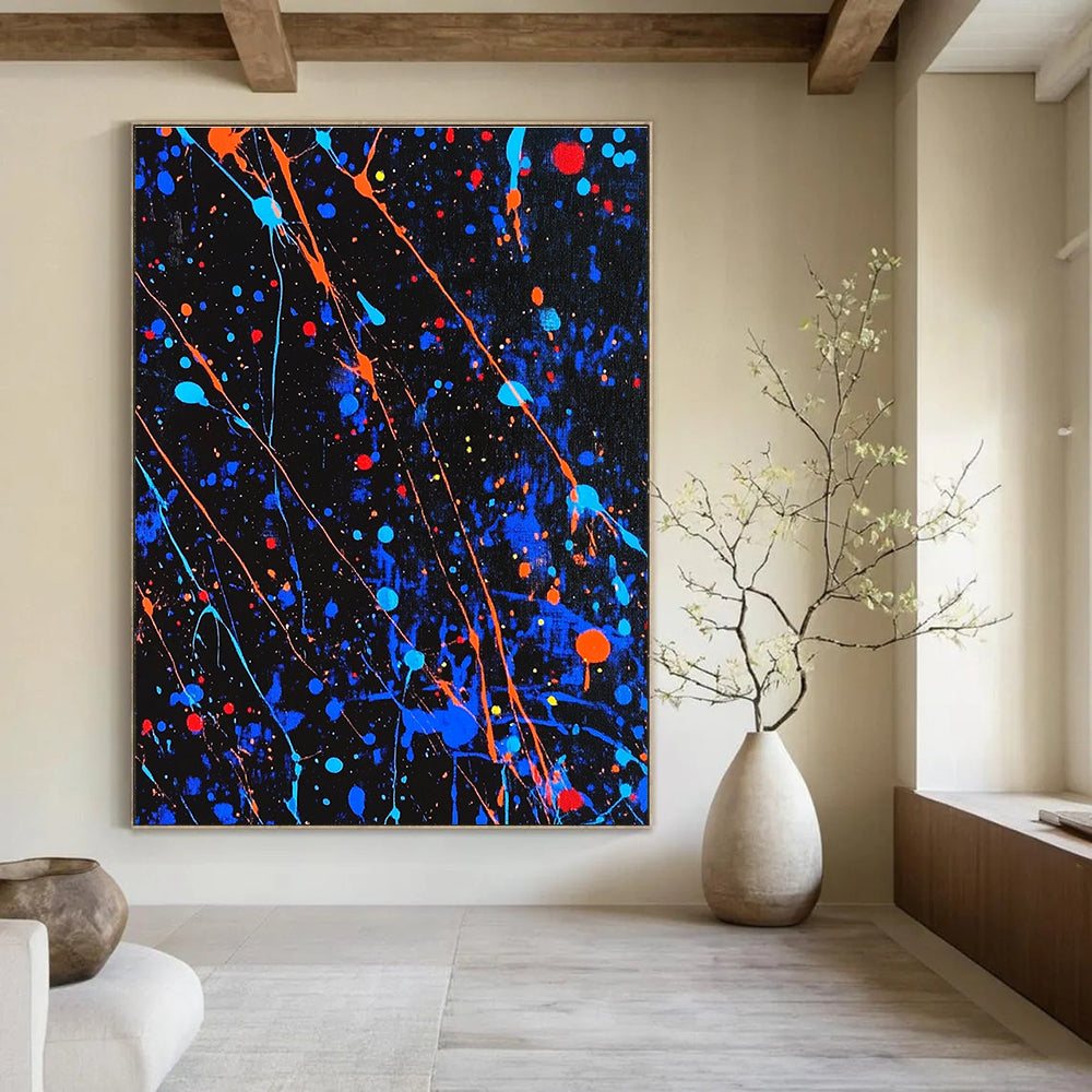 Large abstract painting featuring blue and black splatters with vibrant orange and red highlights for a dynamic artistic statement.STSC1406