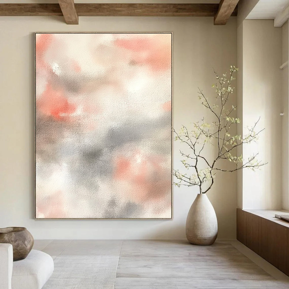 Large abstract painting featuring soft pinks whites and light gray clouds on a beige background creating a serene atmosphere.STSC1462