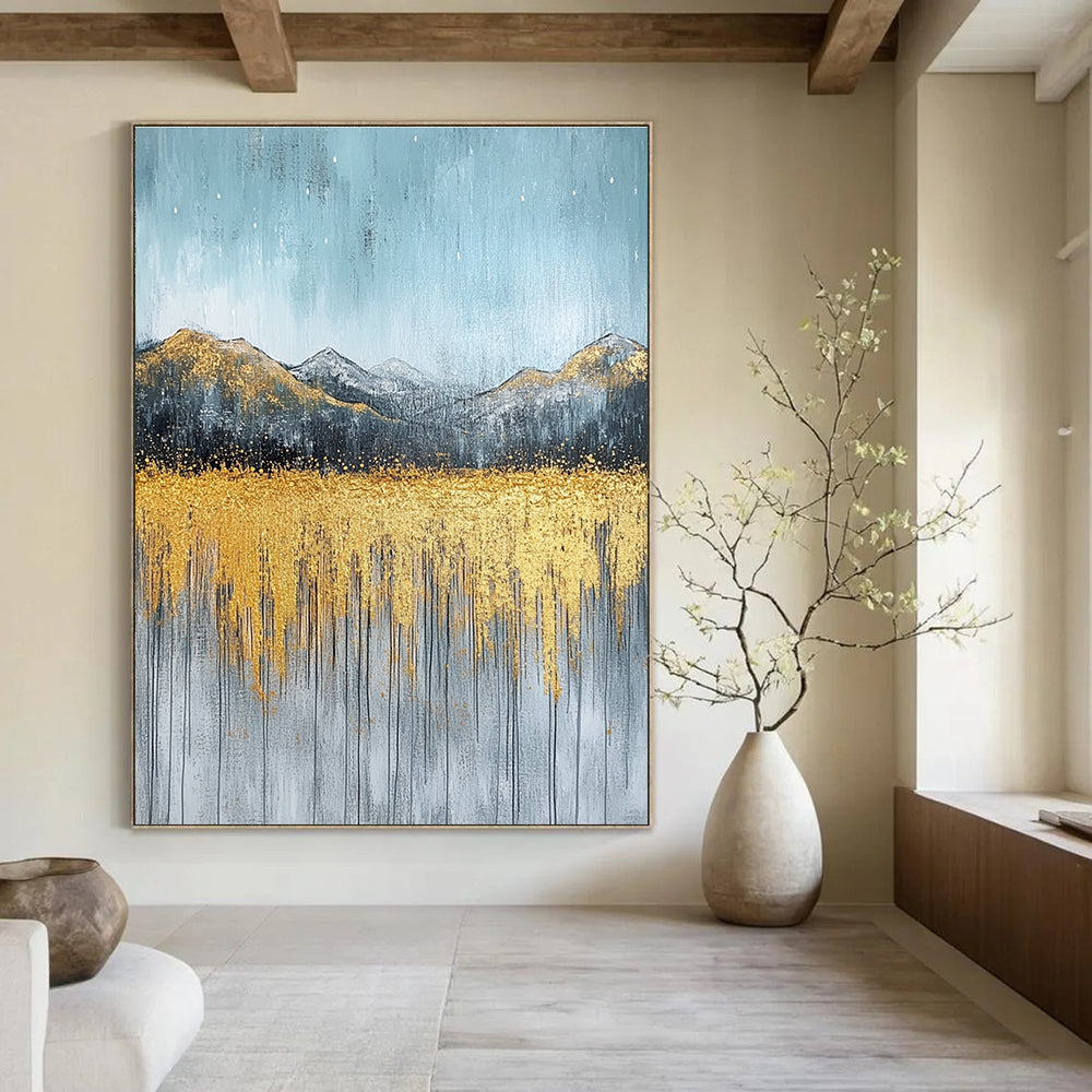 Large abstract painting with gold and silver on textured canvas featuring a serene sky golden mountains and soft gray grass.STSC097
