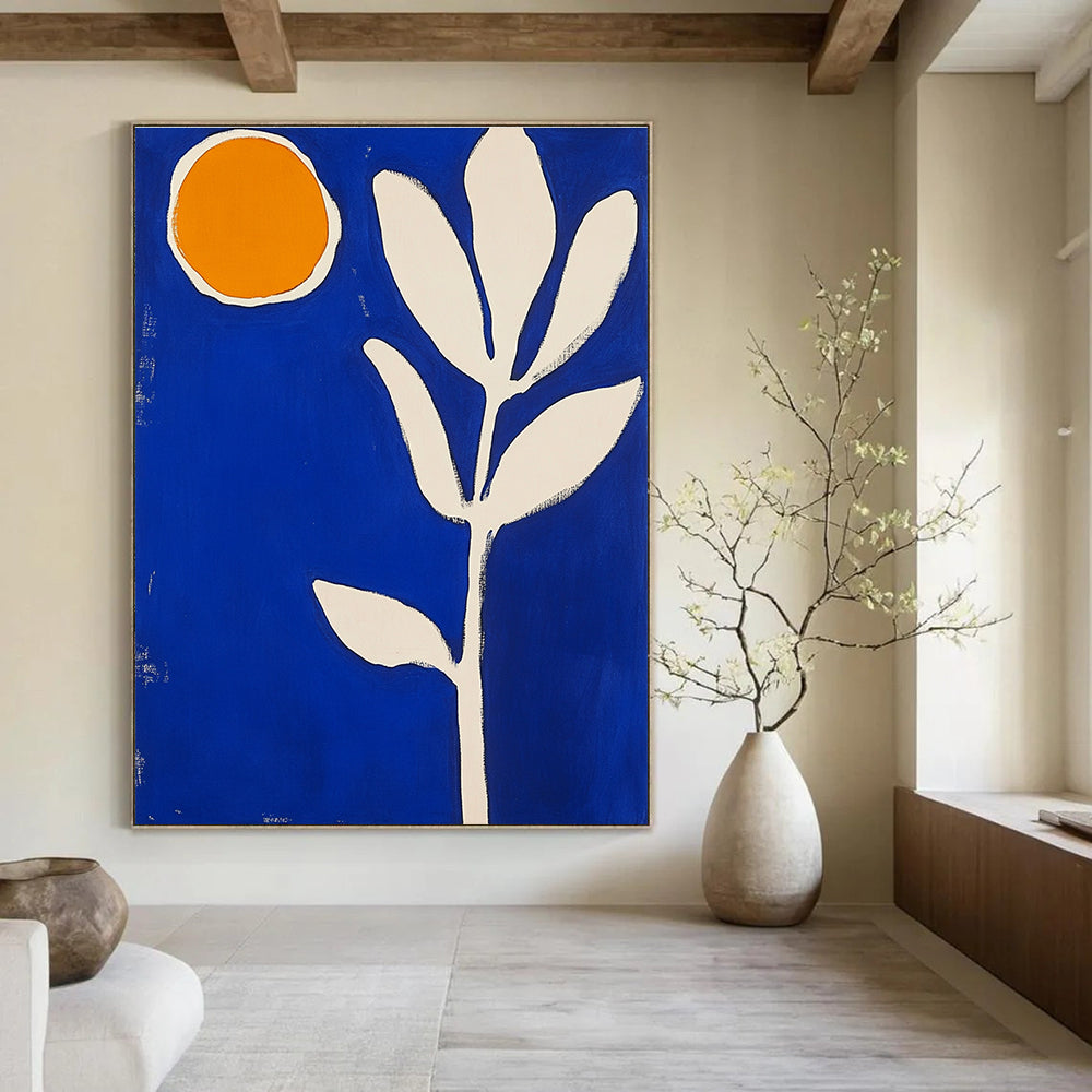 Large abstract painting featuring blue and white shapes an orange sun and a thick brush stroke flower in vibrant colors.STSC1316