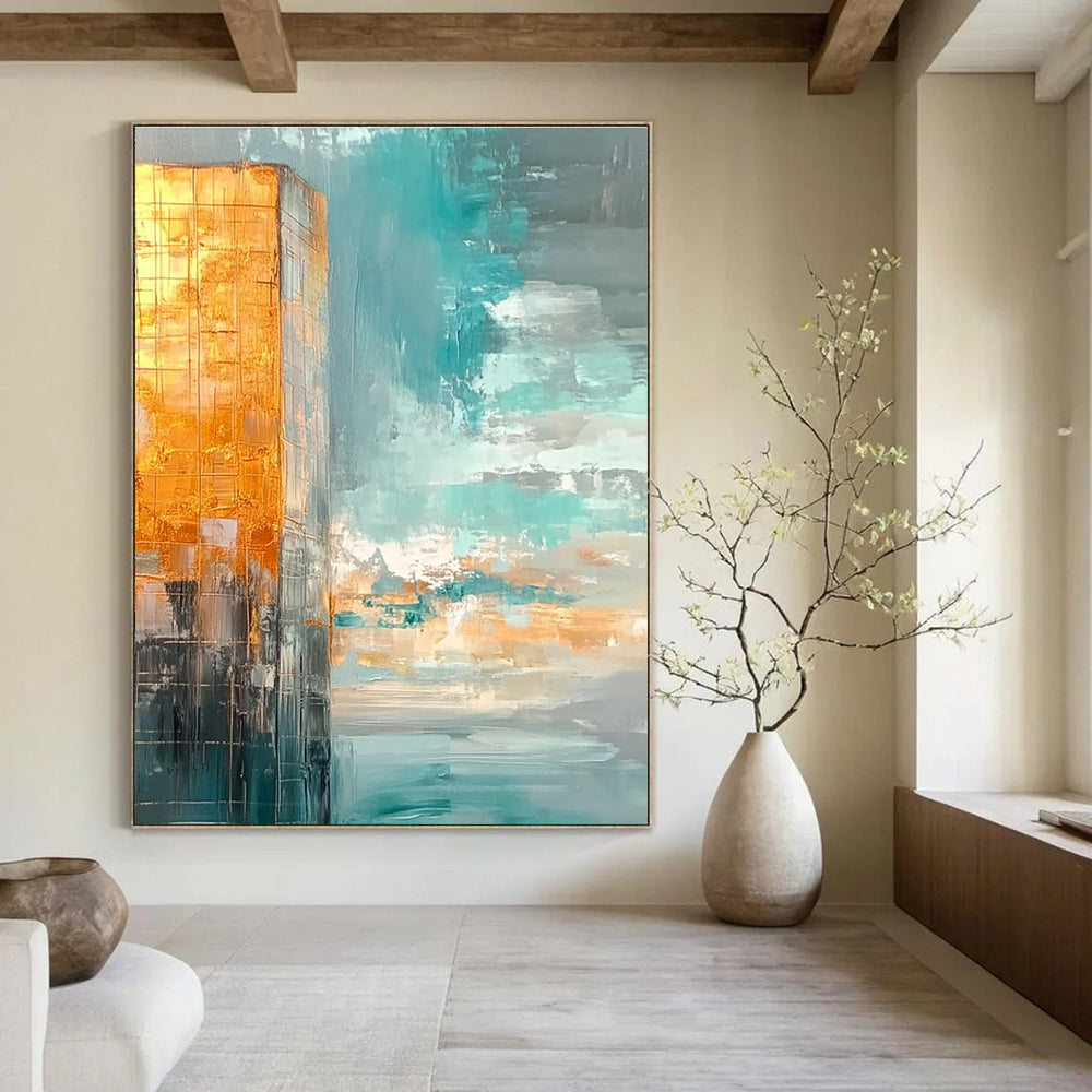 Large abstract painting featuring muted teal and gold tones with a vast sky clouds and calm water creating a serene atmosphere.STSC090