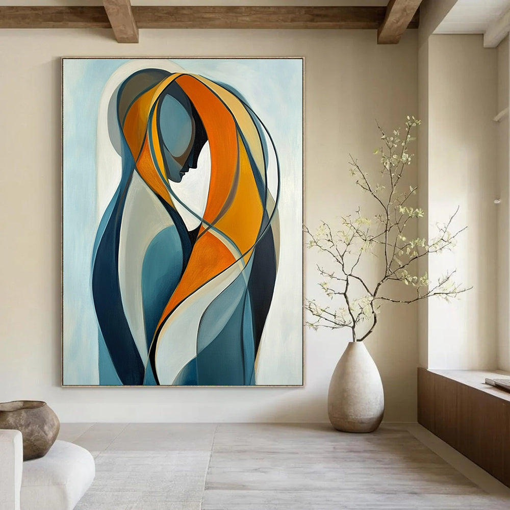 Large abstract painting of two intertwined figures in vibrant orange and yellow against a light blue background emphasizing connection and softness.STSC1143