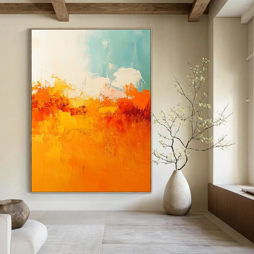 Large abstract painting featuring warm tones of orange and yellow with soft edges and brushstrokes depicting a serene sunset sky.STSC119