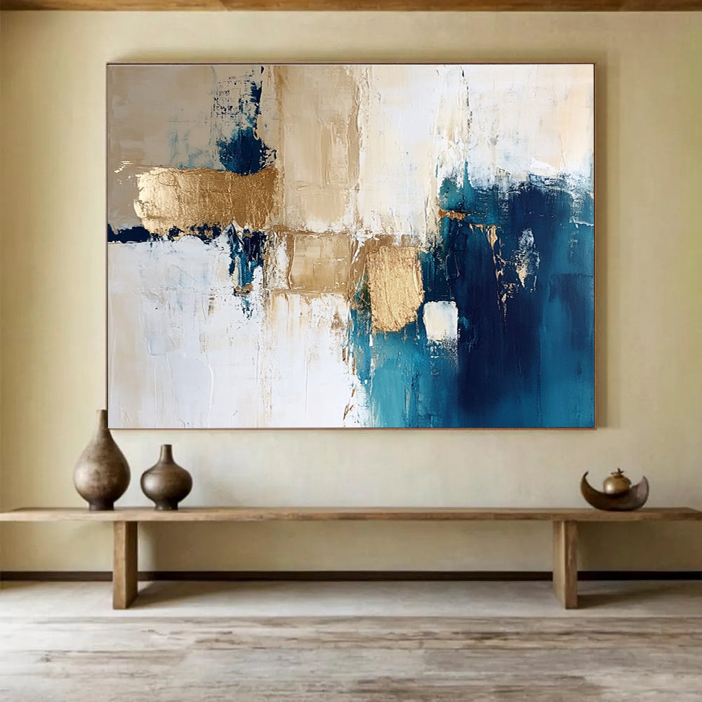 Large abstract painting in blue and gold with white beige and cream tones ideal for modern decor and artistic spaces.SC024