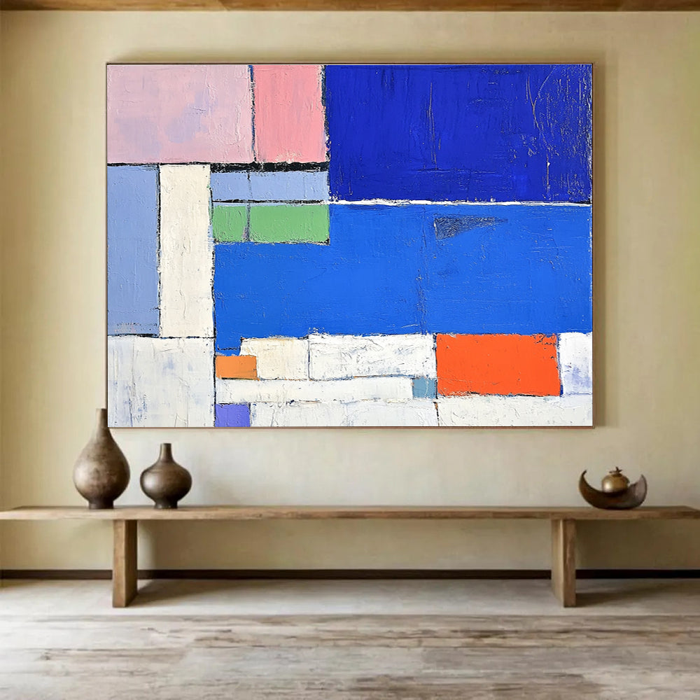 Large abstract painting featuring a vibrant blue sea white beach and colorful hotel with thick brush strokes and geometric shapes.SC169