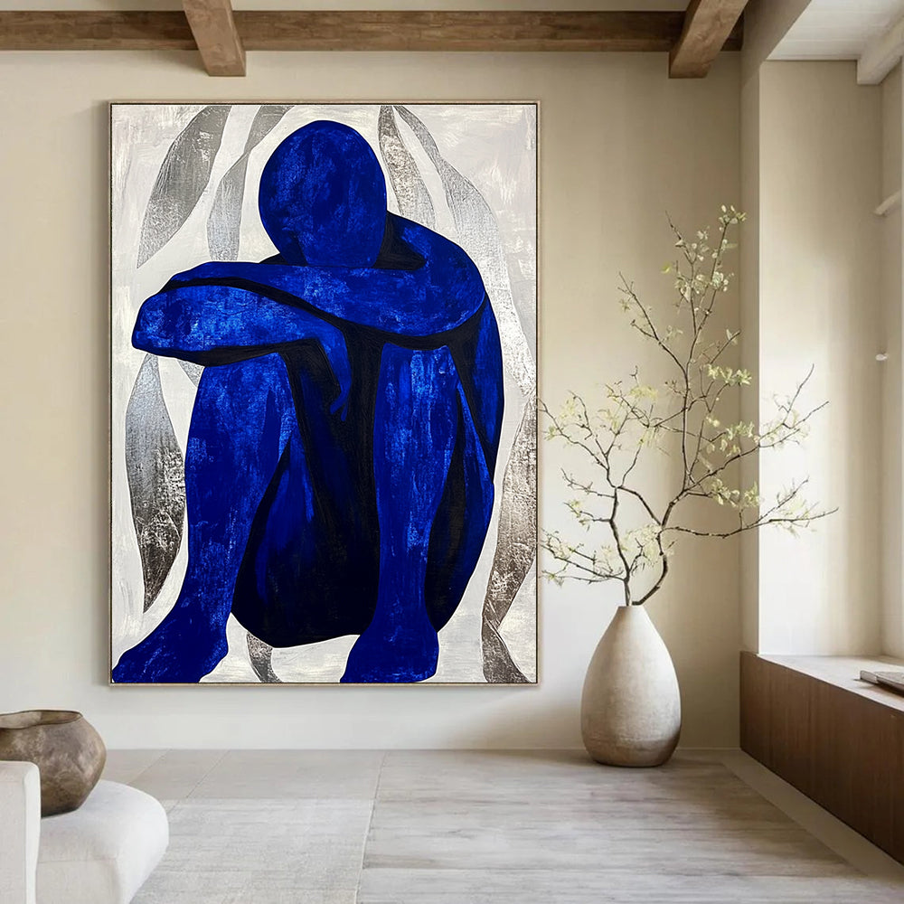 Large abstract painting featuring a contemplative blue figure amidst silver swirls, evoking tranquility and focus in a minimalist style.STSC922