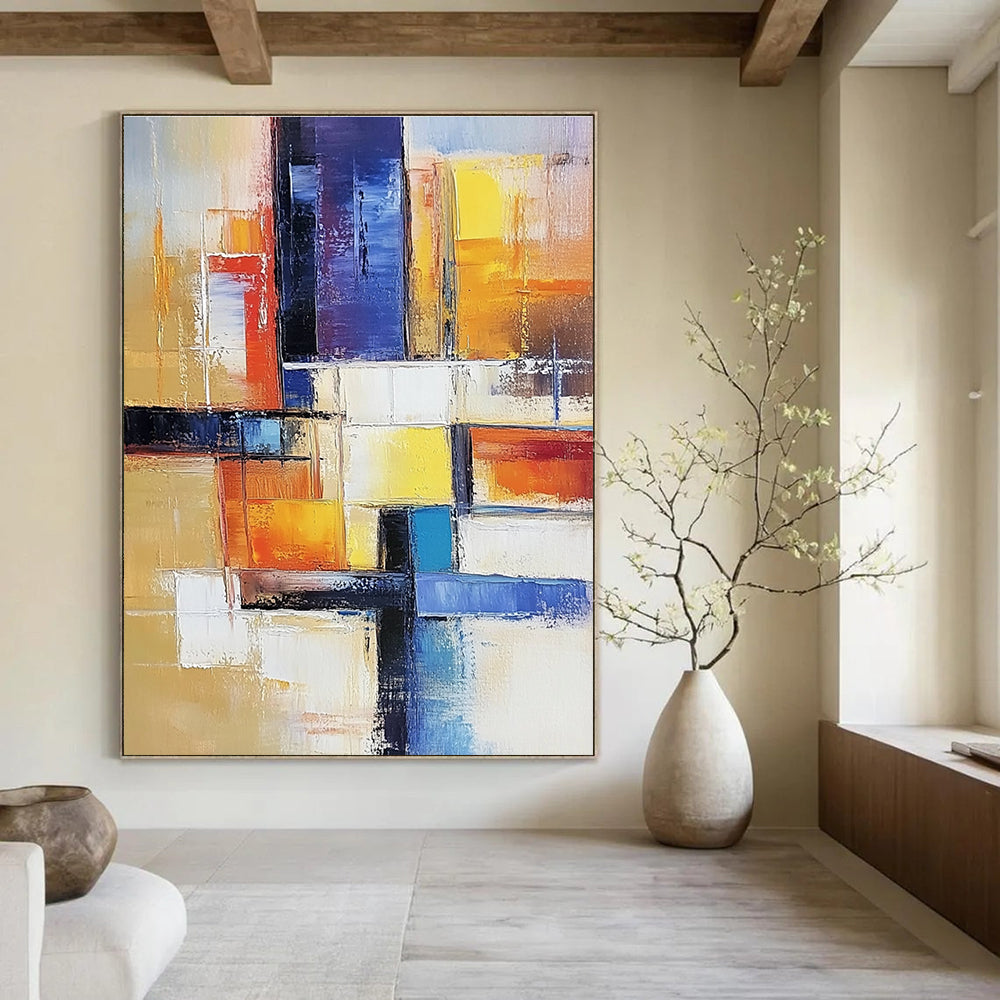Large abstract painting of an urban landscape in warm colors featuring geometric shapes and soft lines on canvas.STSC153
