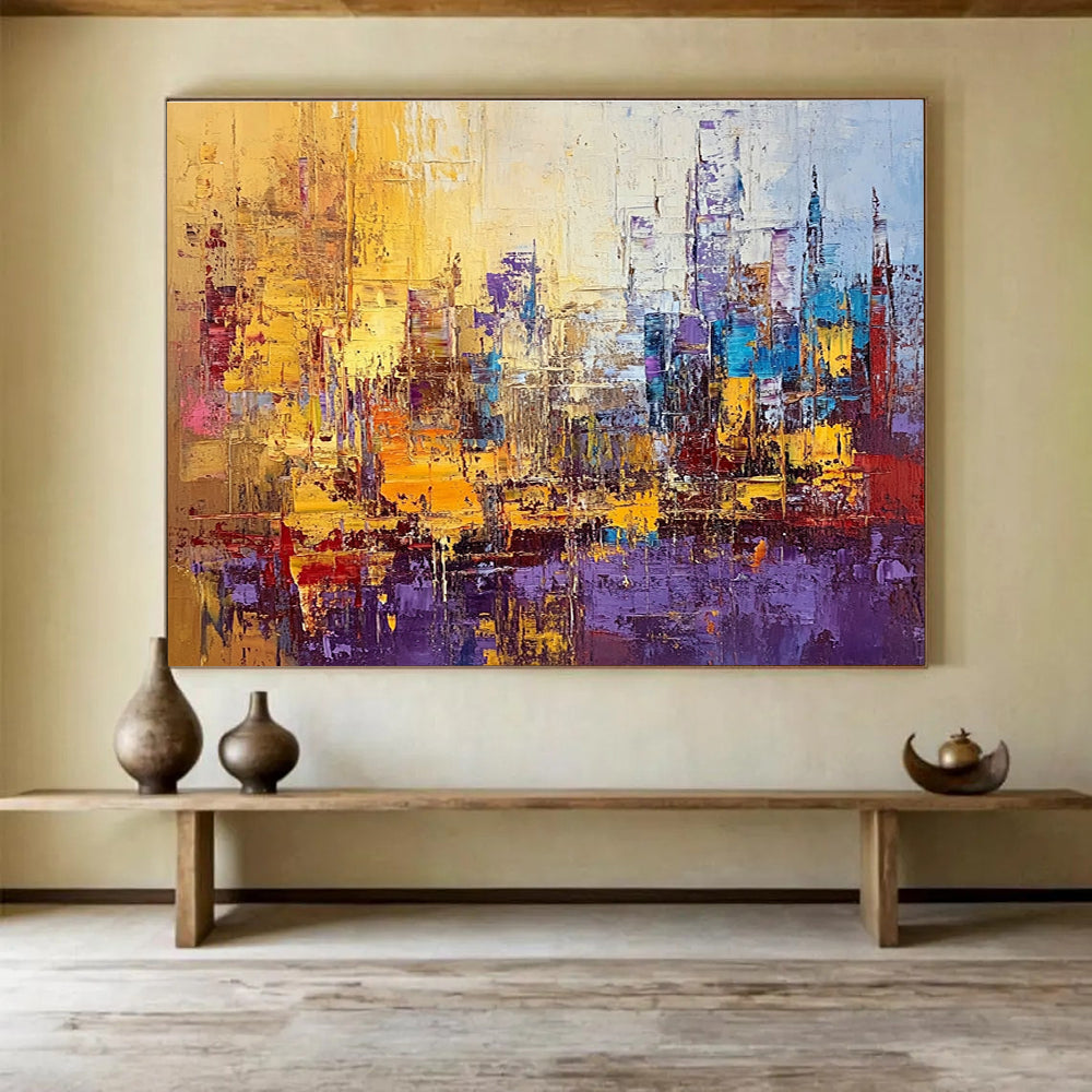 Large abstract painting of a vibrant cityscape in textured gold blue purple and red with impasto strokes and palette knife techniques.SC355