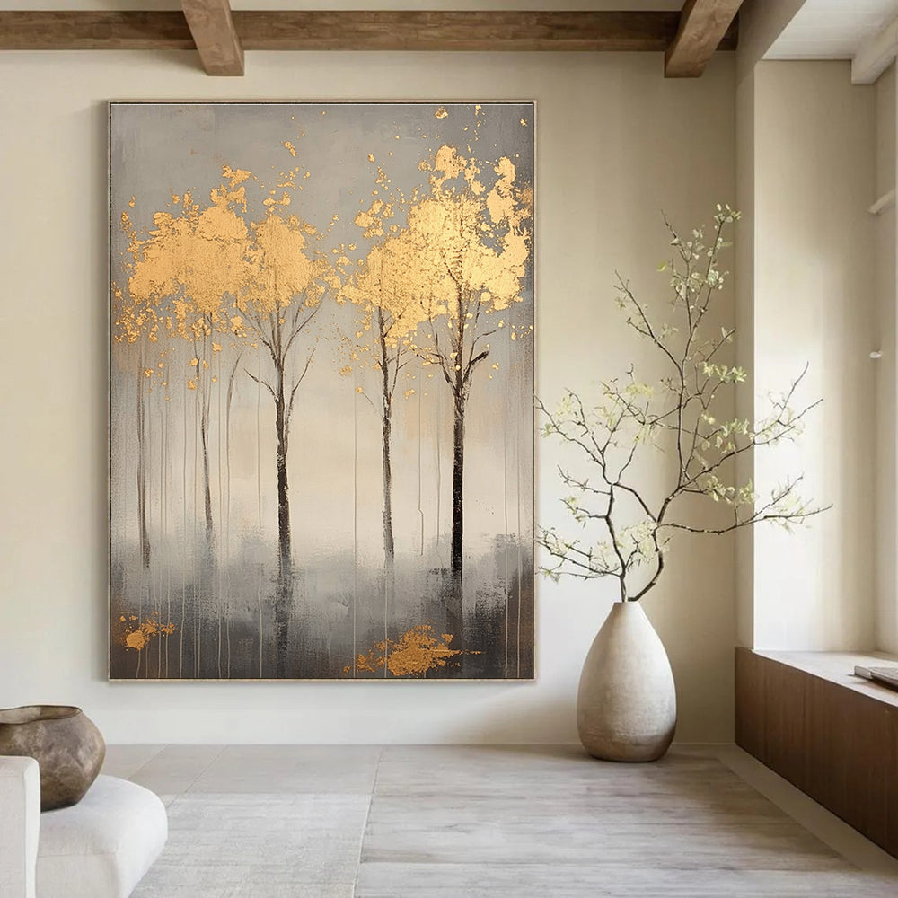A large abstract painting featuring serene gray trees with gold leaf accents creating a tranquil atmosphere and evoking nature's beauty.STSC1174
