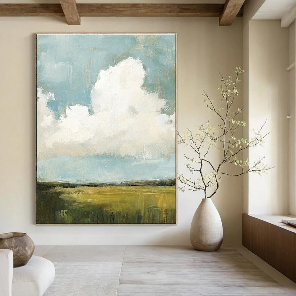 Large abstract painting featuring fluffy white and gray clouds over green grass fields with visible brush strokes and muted colors, creating a detailed scene.STSC873