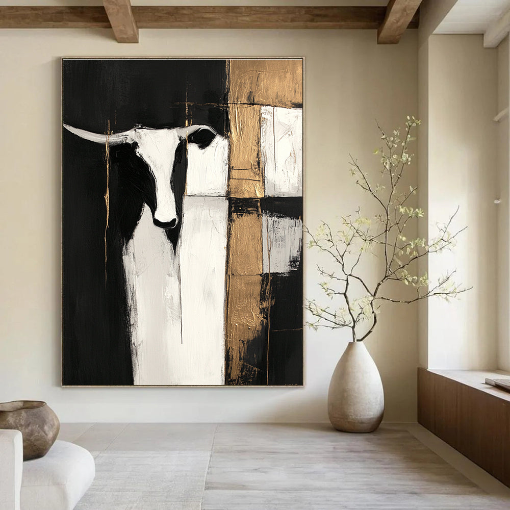 Large abstract painting in black and white with gold accents featuring cow shapes and wood planks on a dark background with visible brush strokes.STSC223