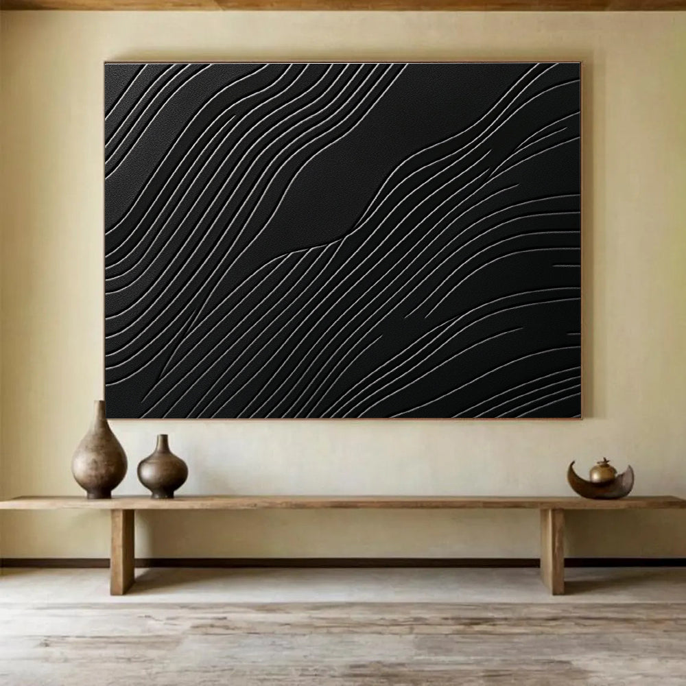 A large abstract artwork featuring elegant wave patterns on a matte black surface, showcasing layered textures and high contrast between light and dark tones.SC575