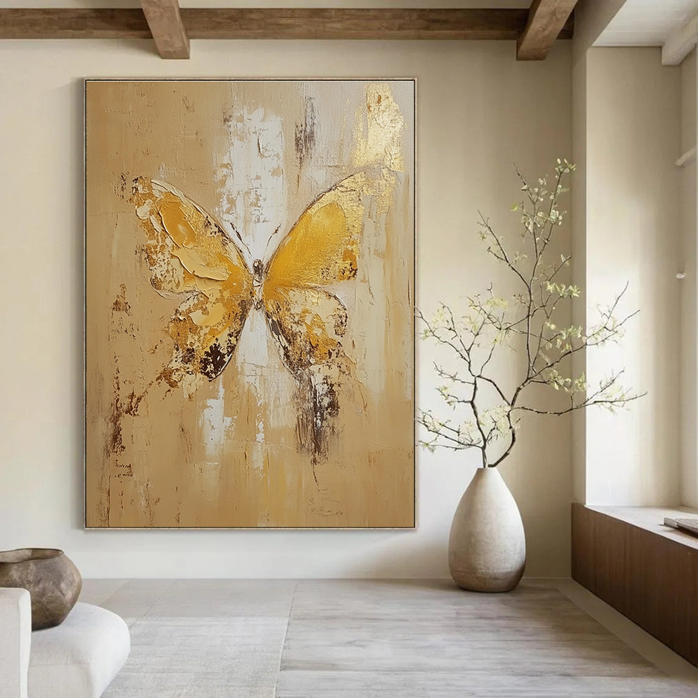Large abstract painting of a butterfly in light yellow and beige tones with gold leaf and textured oil on canvas.STSC252