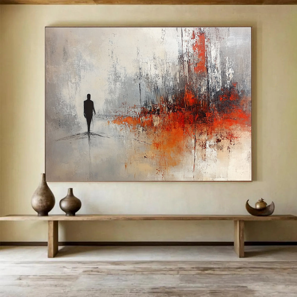 Large abstract painting in soft gray and white tones with red and orange splashes featuring a silhouette in an ominous landscape.SC258