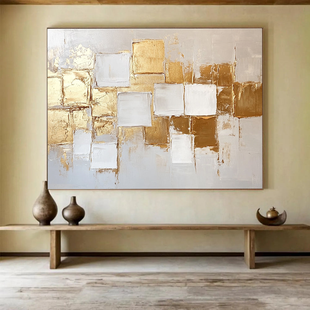 Large abstract painting in white and gold featuring textured square block patterns and soft lighting for an elegant touch.SC292