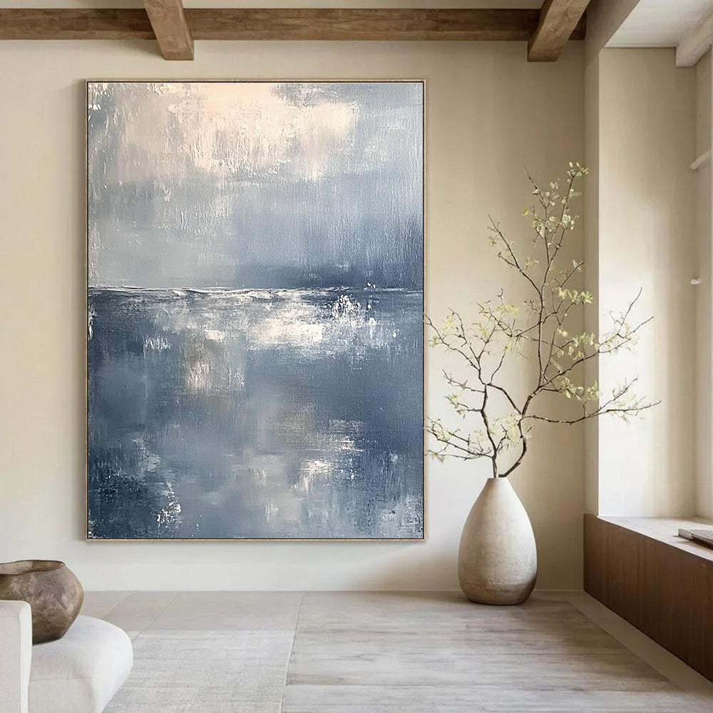 Large abstract painting of a serene ocean horizon in muted gray and white tones with soft brushstrokes conveying tranquility and elegance.STSC262