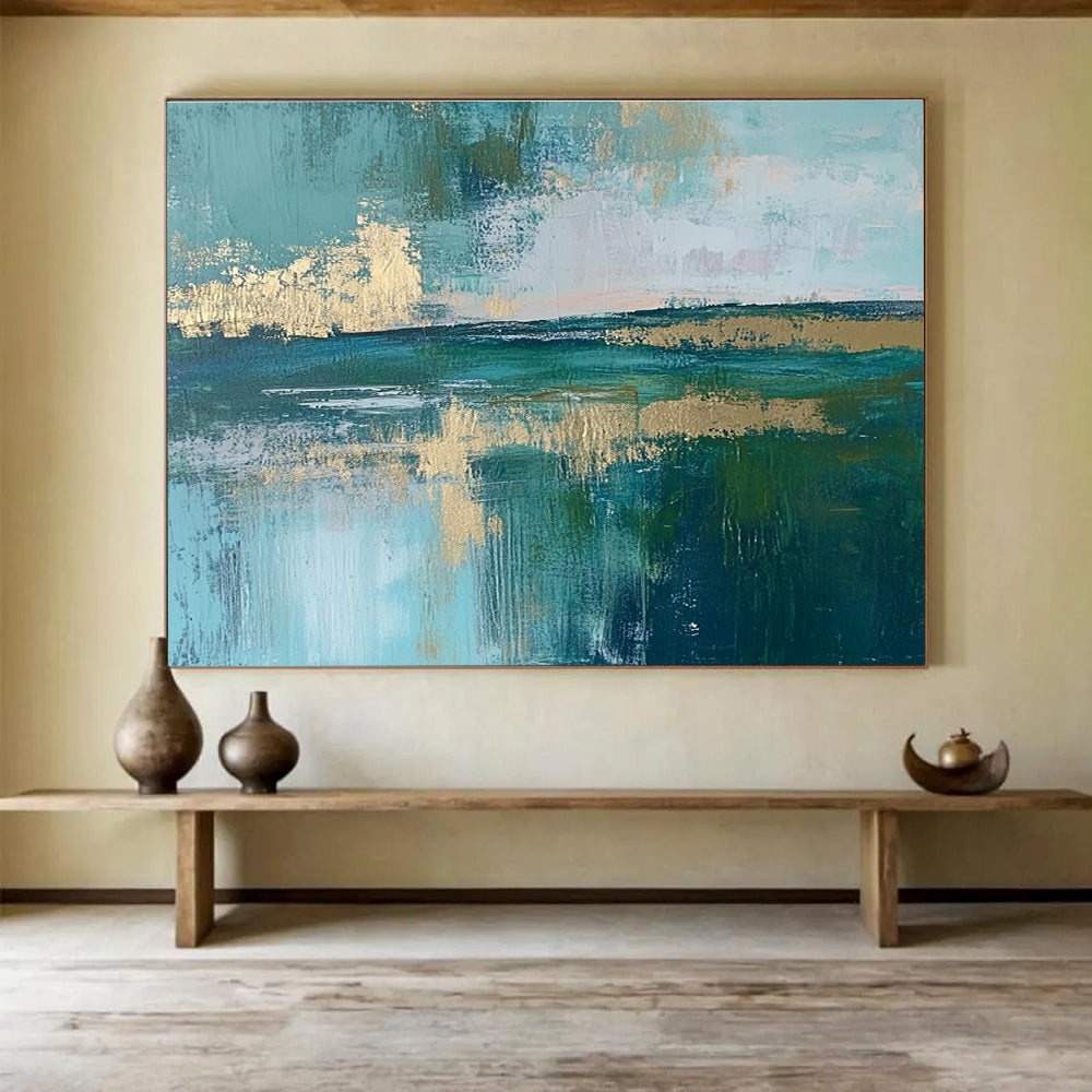 Large abstract painting featuring a serene lake, vibrant green fields, light blue sky, and elegant gold foil accents.SC115