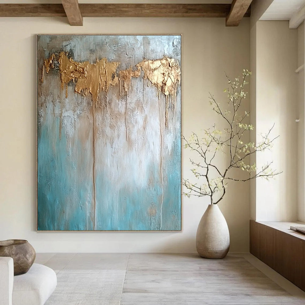 Large abstract painting with texture in neutral tones featuring light blue brown and gold hues highlighting water damage elements against a concrete wood background.STSC136