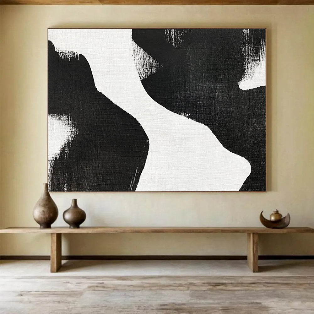 Large abstract painting featuring black and white brush strokes depicting two women’s bodies against a plain white background, showcasing minimalist artistry and tranquil form.SC439